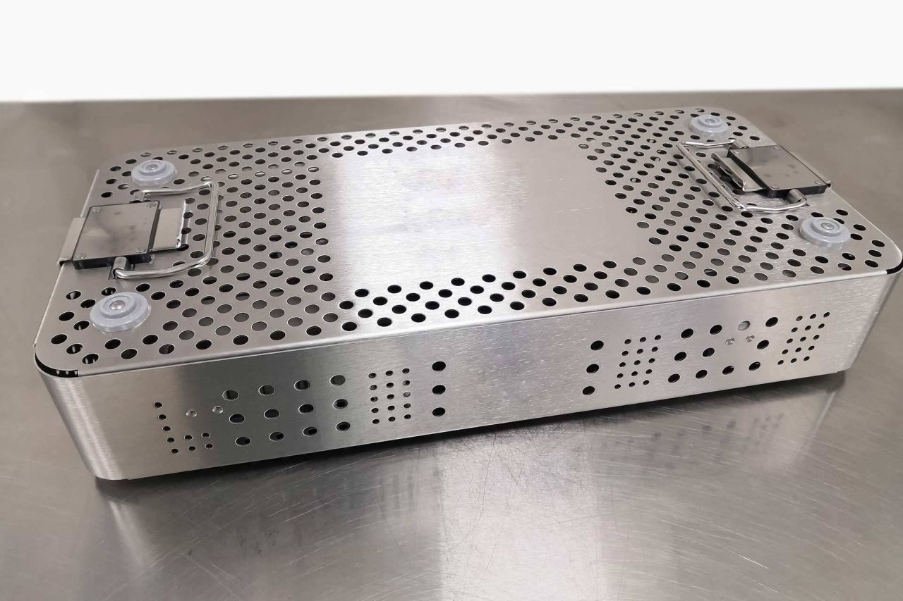 Metal case with holes in it as part of SteriLogix's process of reprocessing reusable medical devices