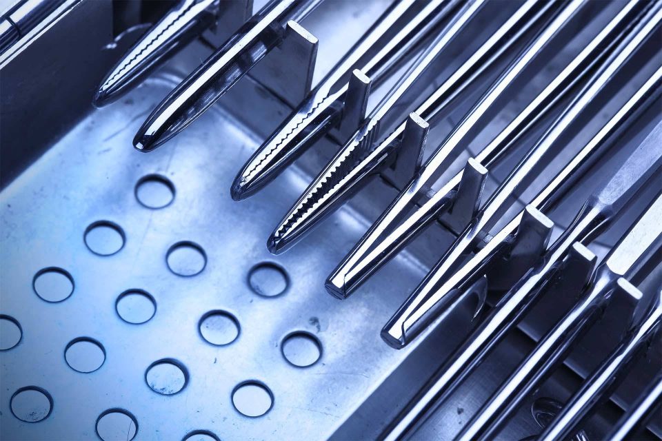 Metal medical tools waiting to be processed through SteriLogix's standardized clinical reprocessing cycles.